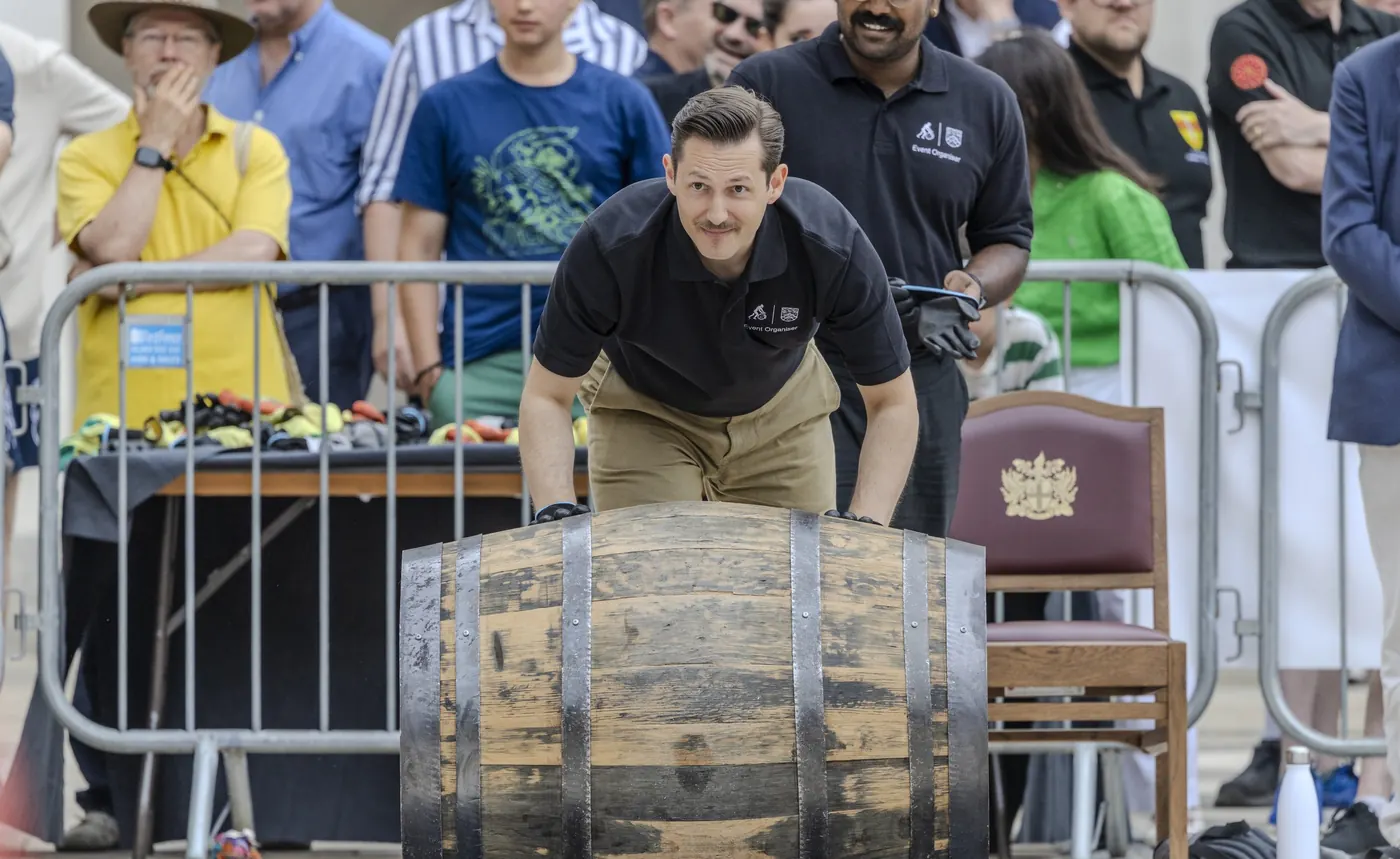 Liam Randall rolling a cask across Guildhall Yard at the Coopers' Cask Race.