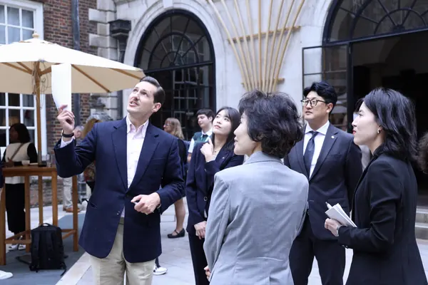 Liam Randall hosting an international delegation in the courtyard of Merchant Taylors' Hall.