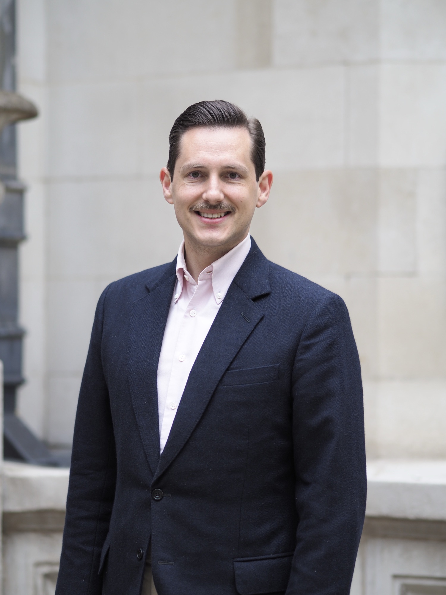Portrait of Liam Randall against the stonework of Merchant Taylors' Hall.